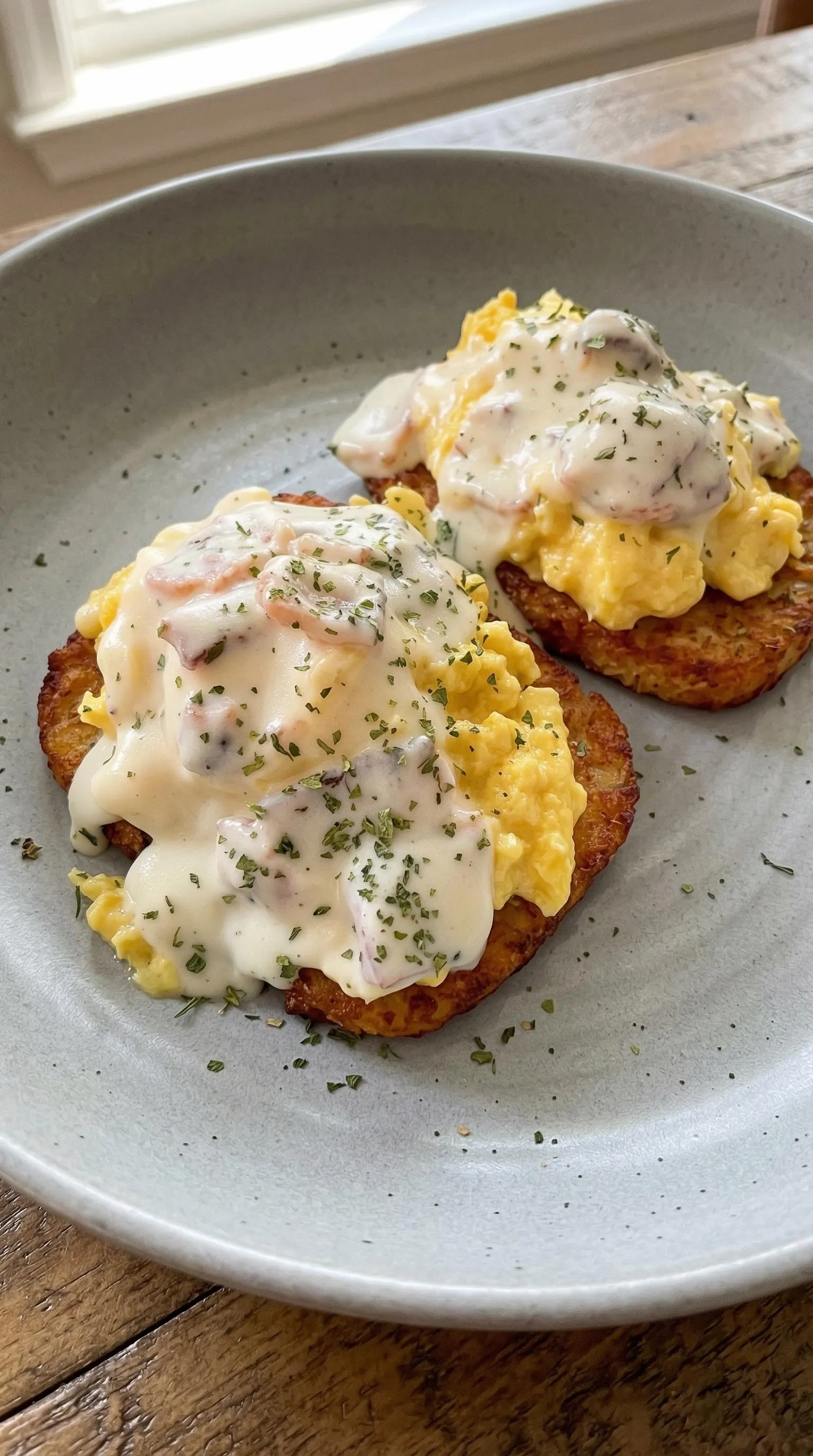 Two pieces of bread with eggs and cheese on top.