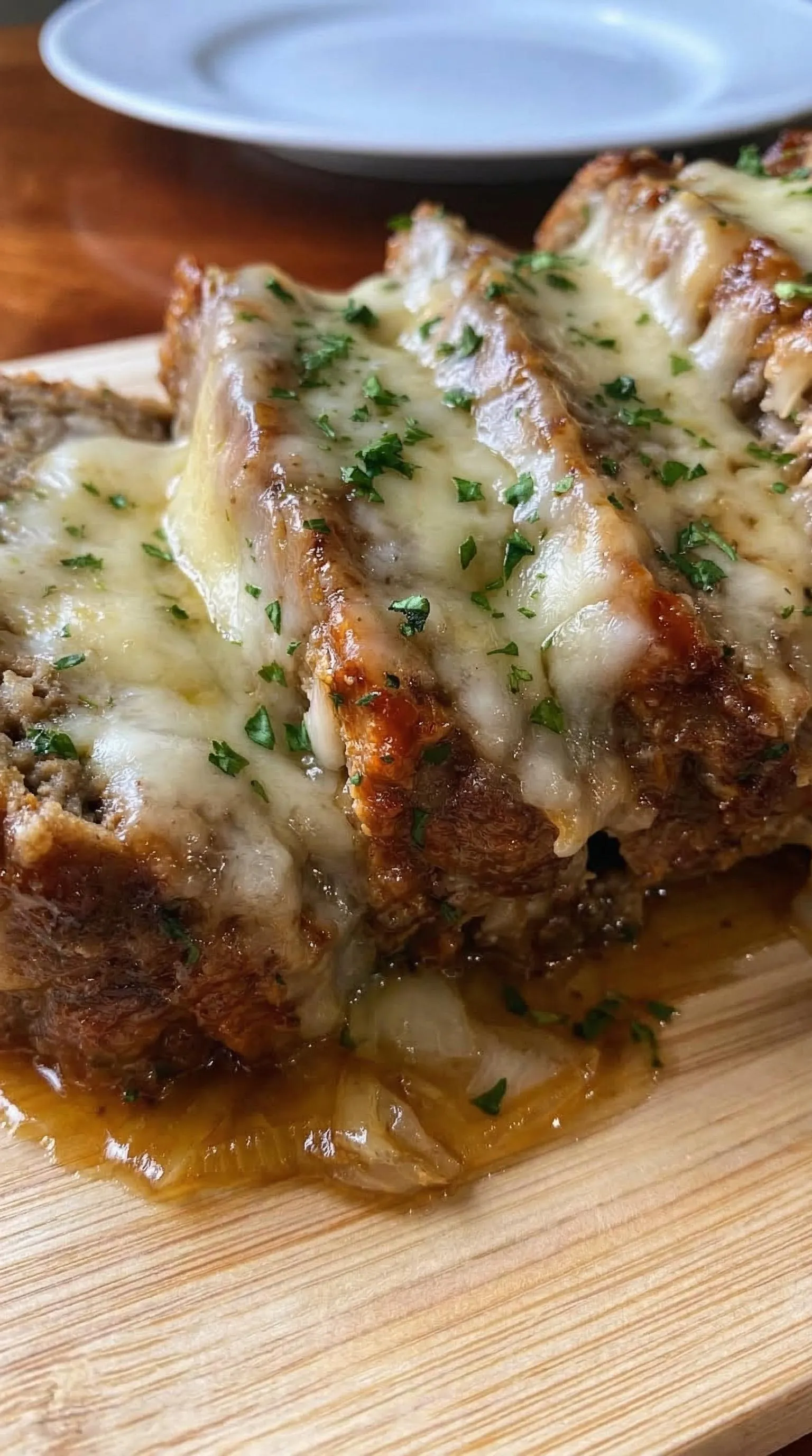 A piece of meat with cheese on it.