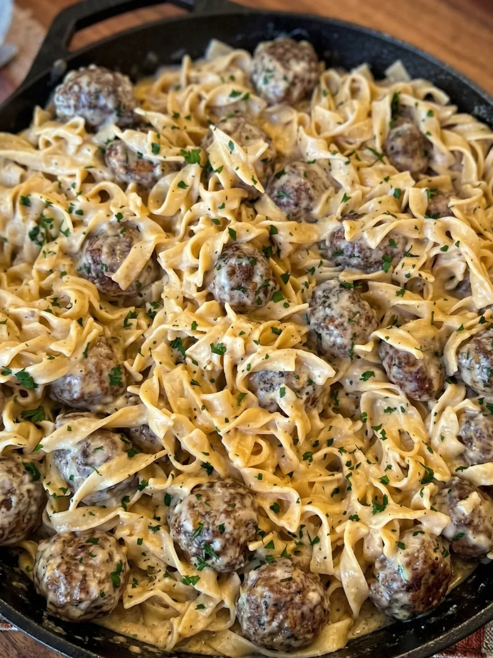 A plate of pasta with meatballs and noodles.