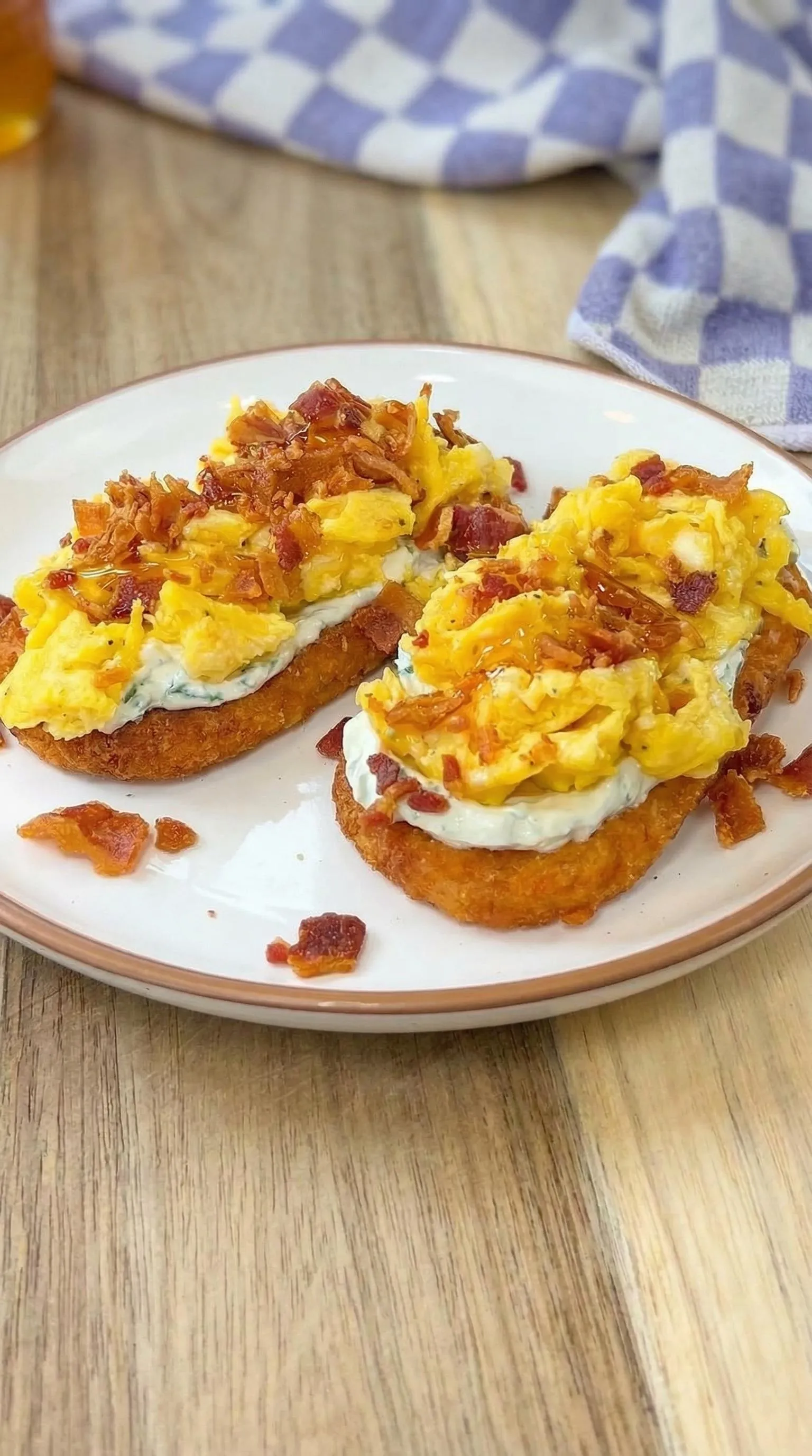 Bacon and egg sandwich on a white plate.