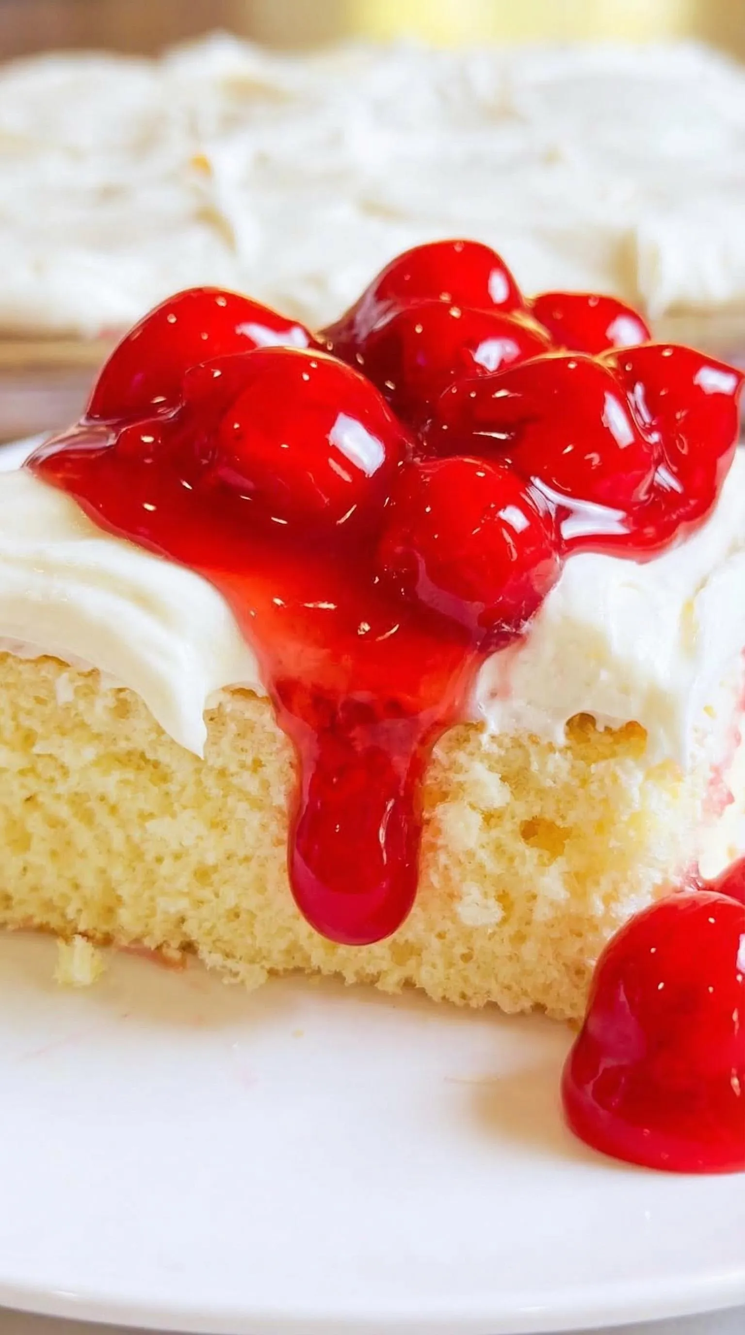 A piece of cake with red jelly on it.