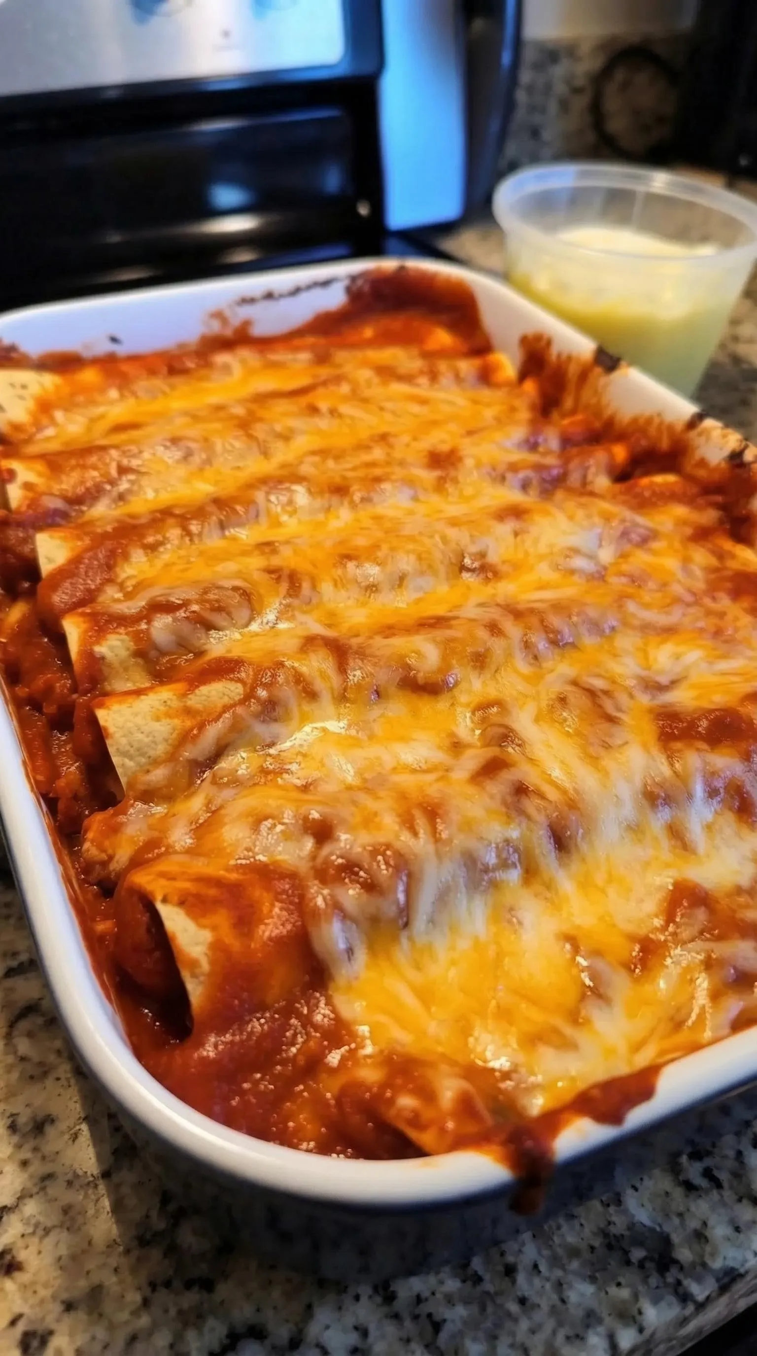 A white bowl filled with a cheesy dish.