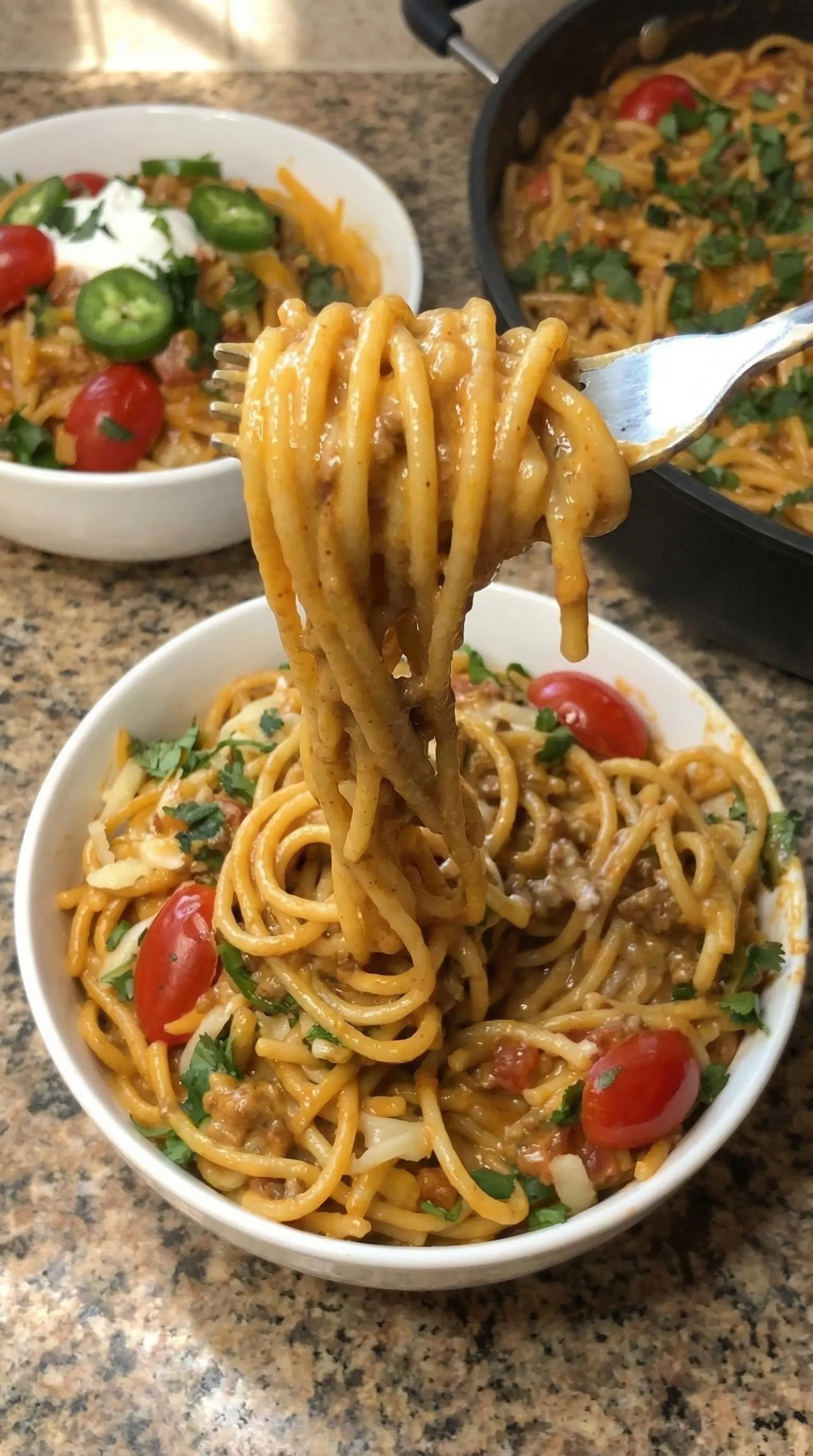 A fork is in a bowl of spaghetti.
