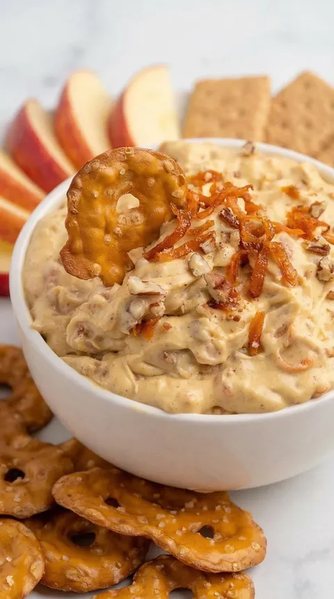 A bowl of food with a pretzel on top.