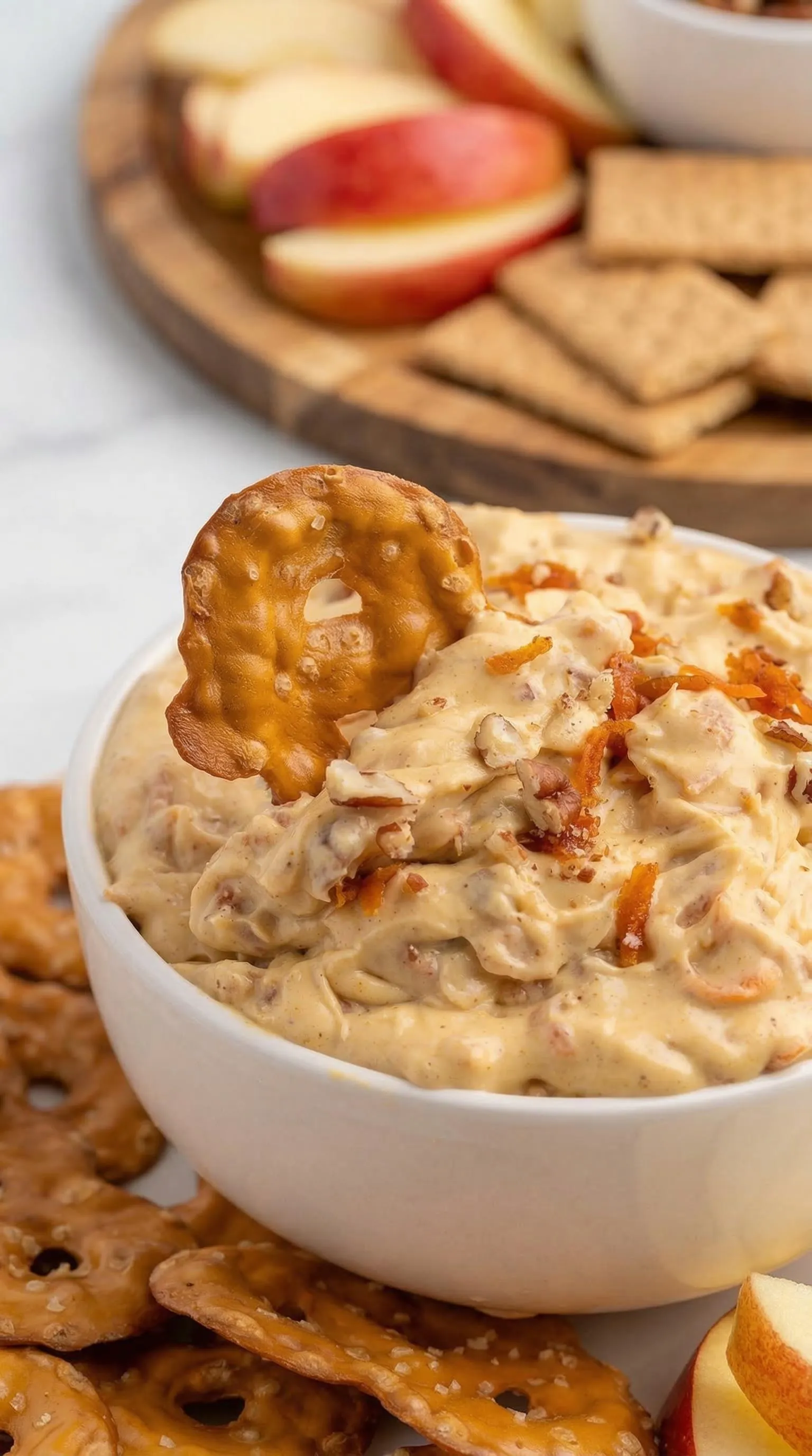 A bowl of food with a pretzel on top.
