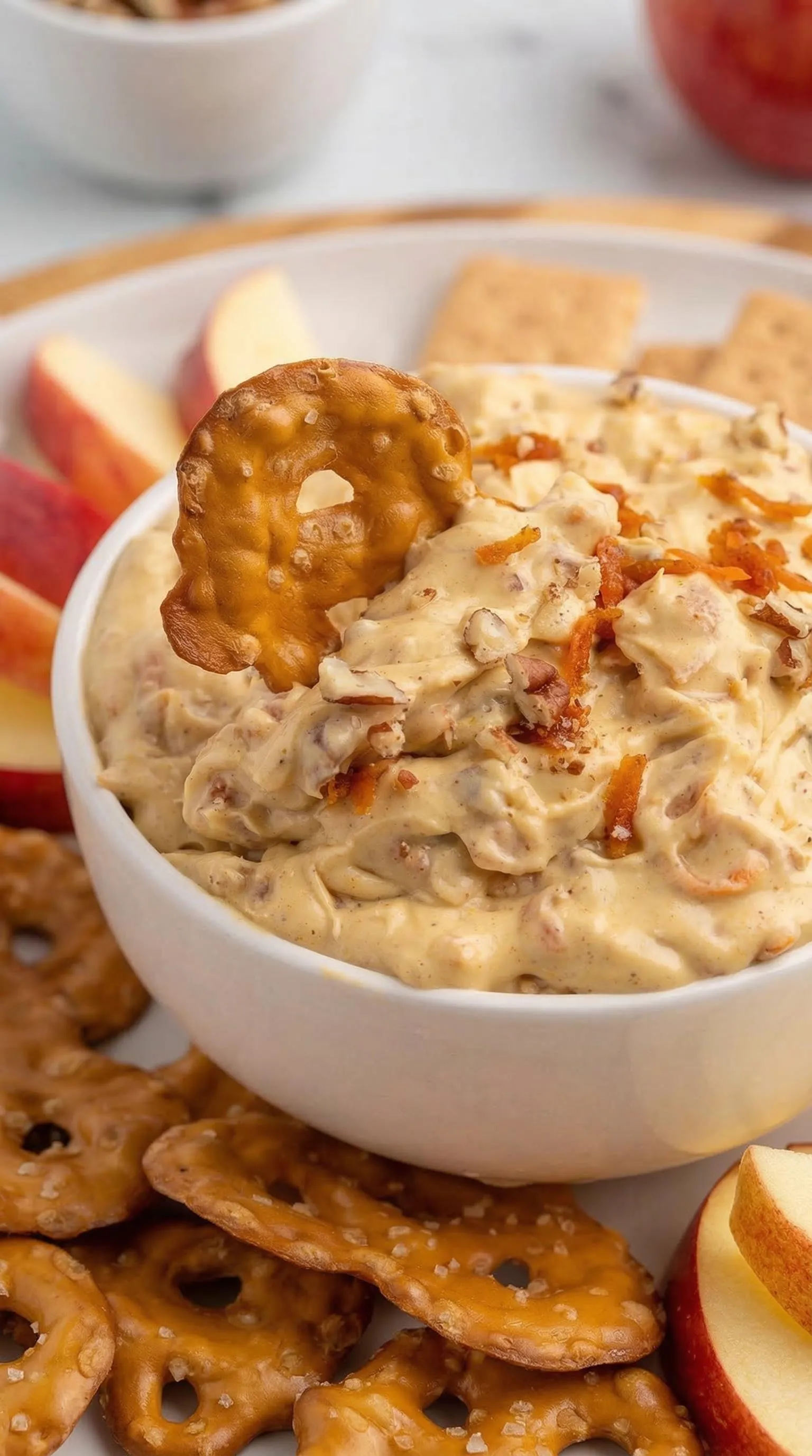 A bowl of food with a cracker on top.