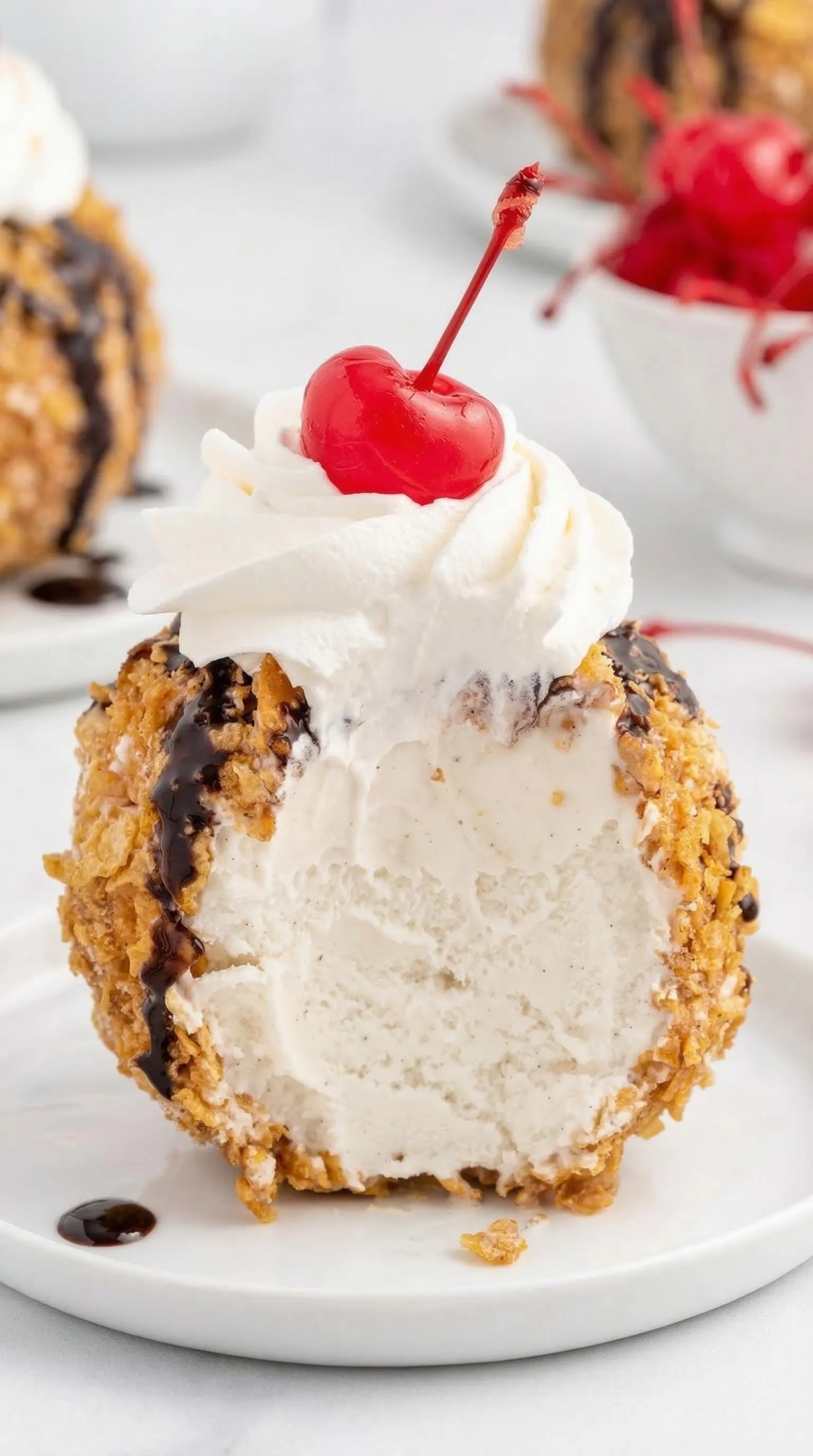 A chocolate covered doughnut with a cherry on top.