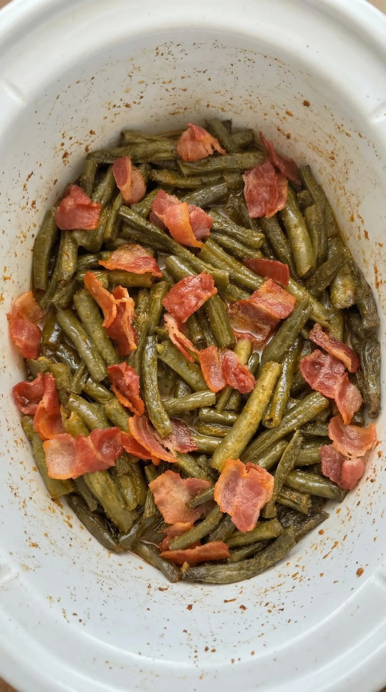 A bowl of bacon and green beans.