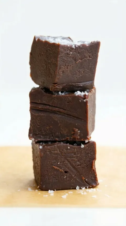 Three pieces of chocolate cake stacked on top of each other.