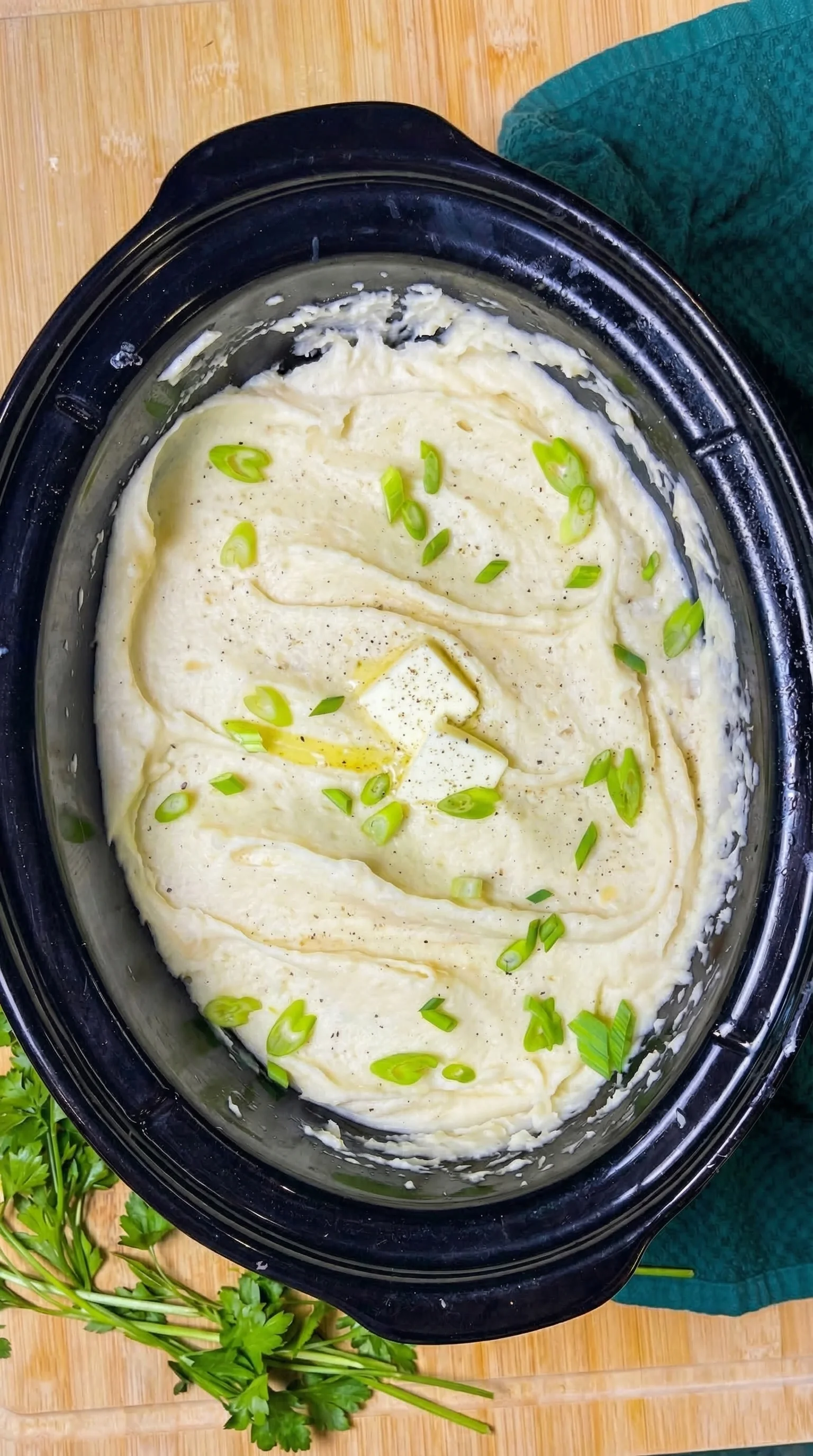 A bowl of mashed potatoes with green onions.