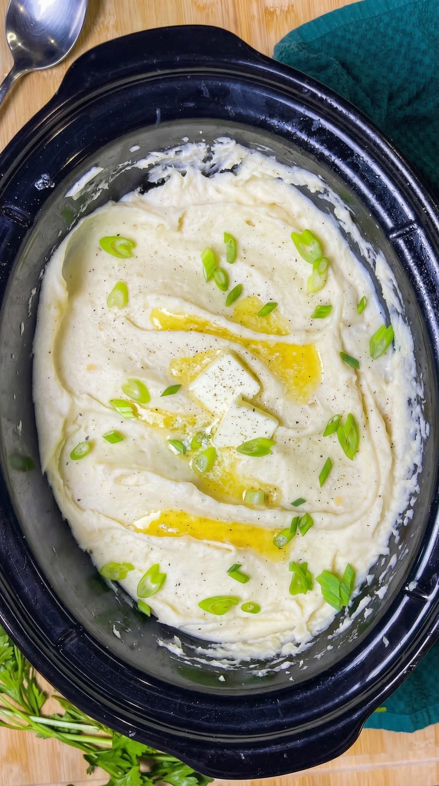 A bowl of mashed potatoes with onions.