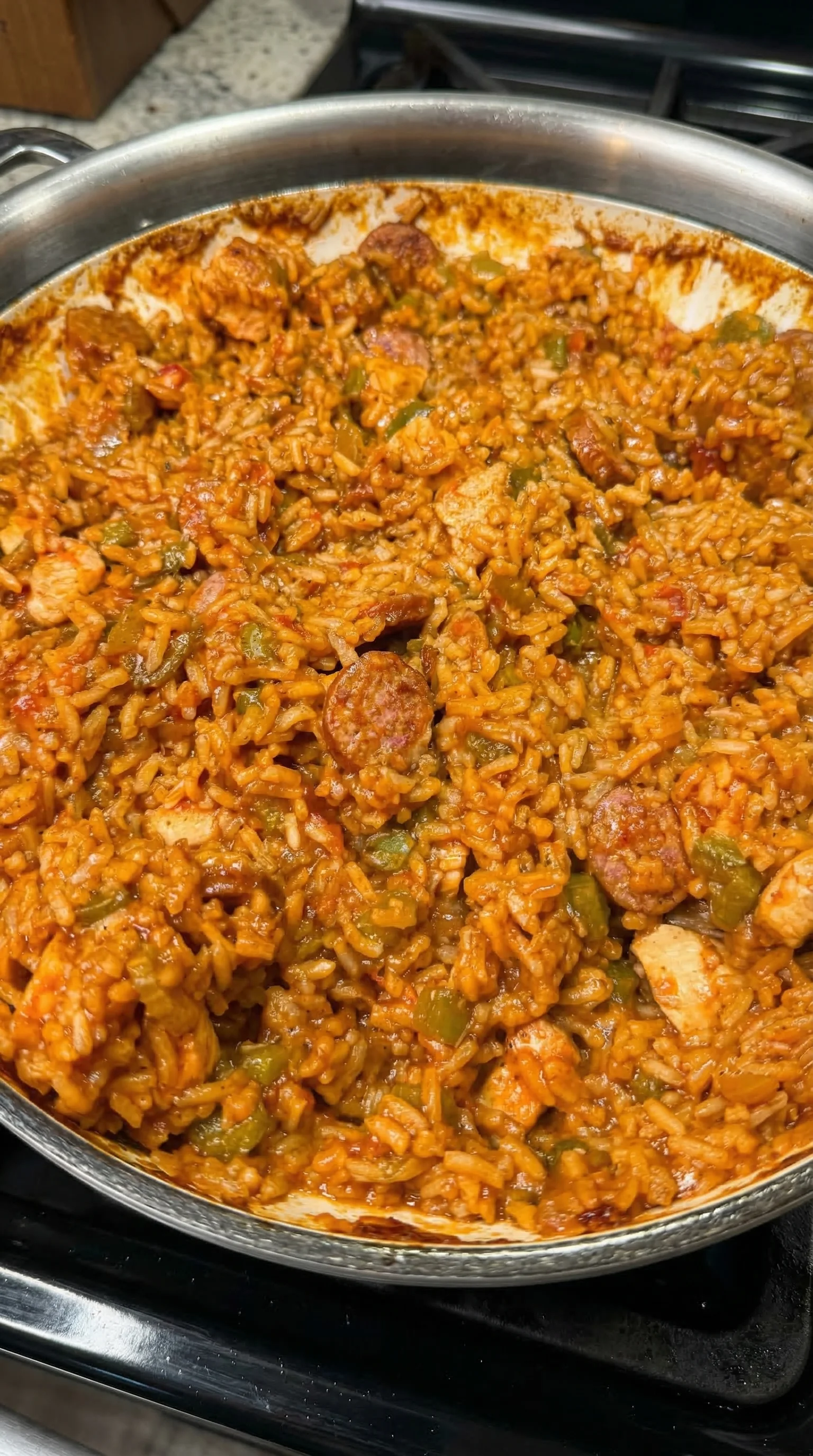 A bowl of rice with sausage.