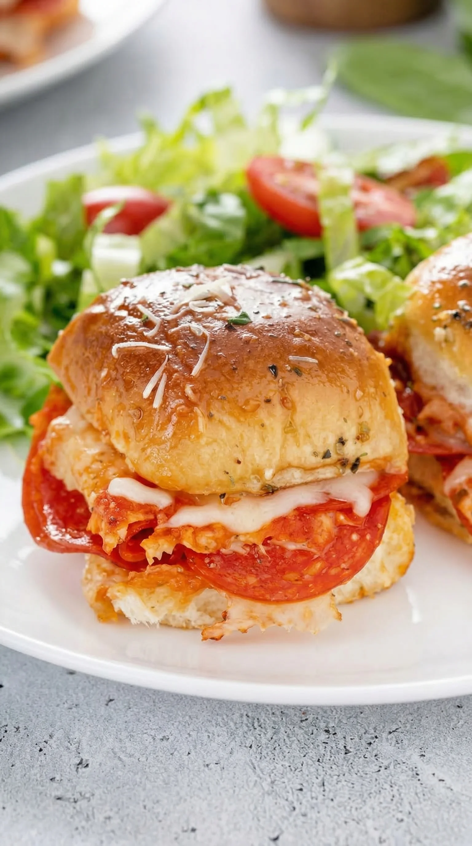 Two sandwiches with tomatoes and cheese.