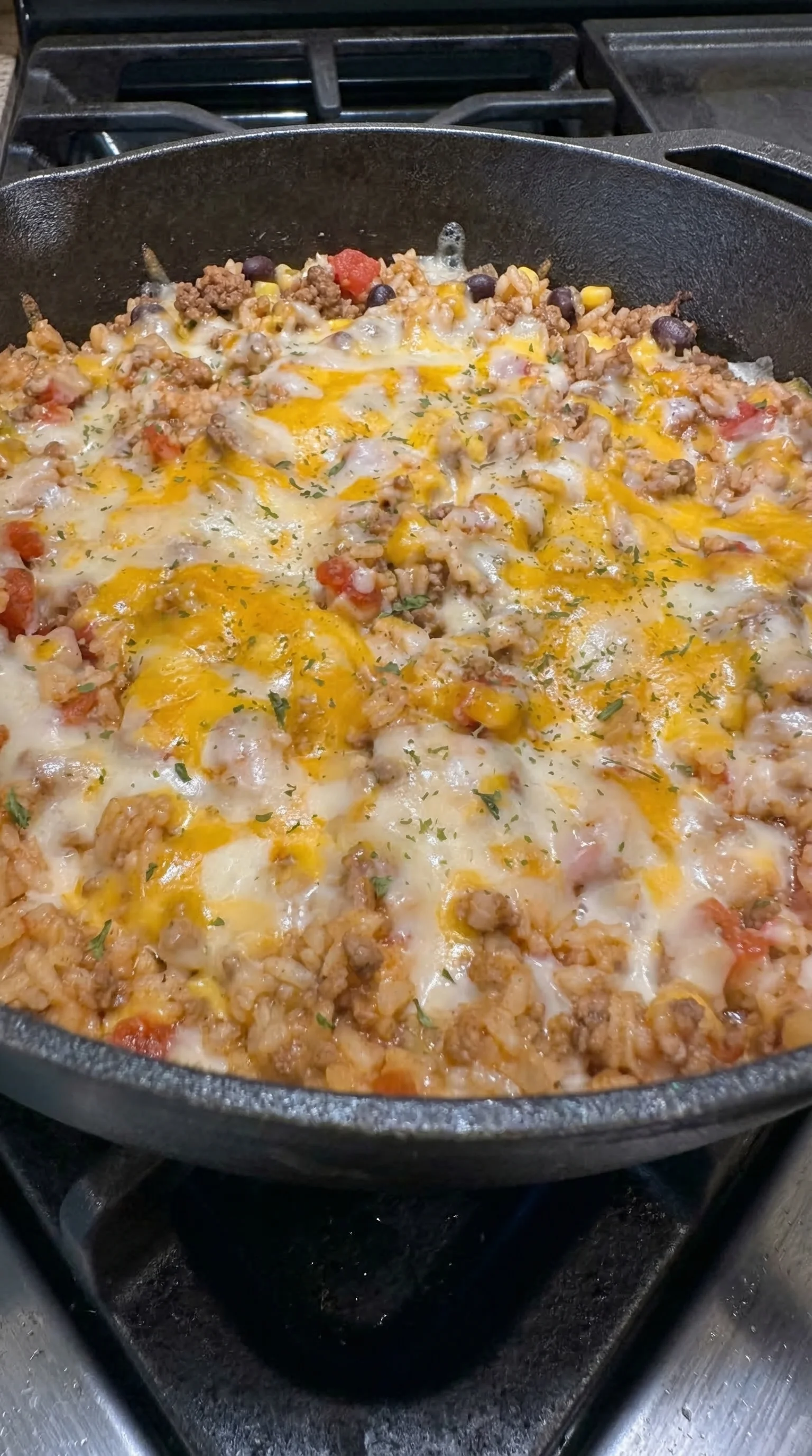 A pan of food with cheese and tomatoes.