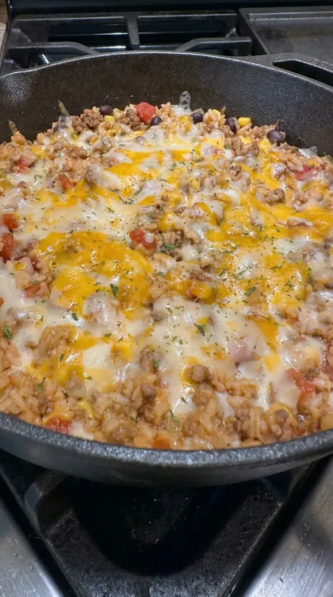 A pan of food with cheese and tomatoes.