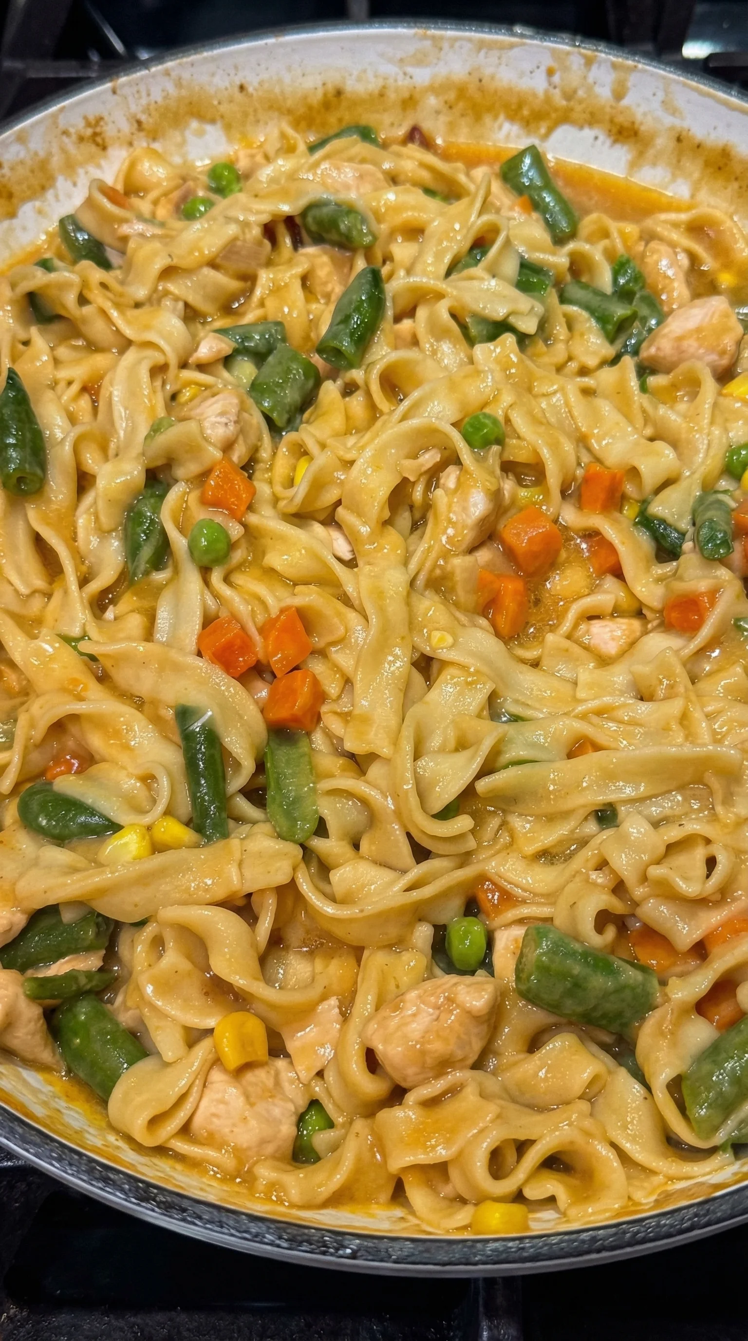A plate of noodles with vegetables.