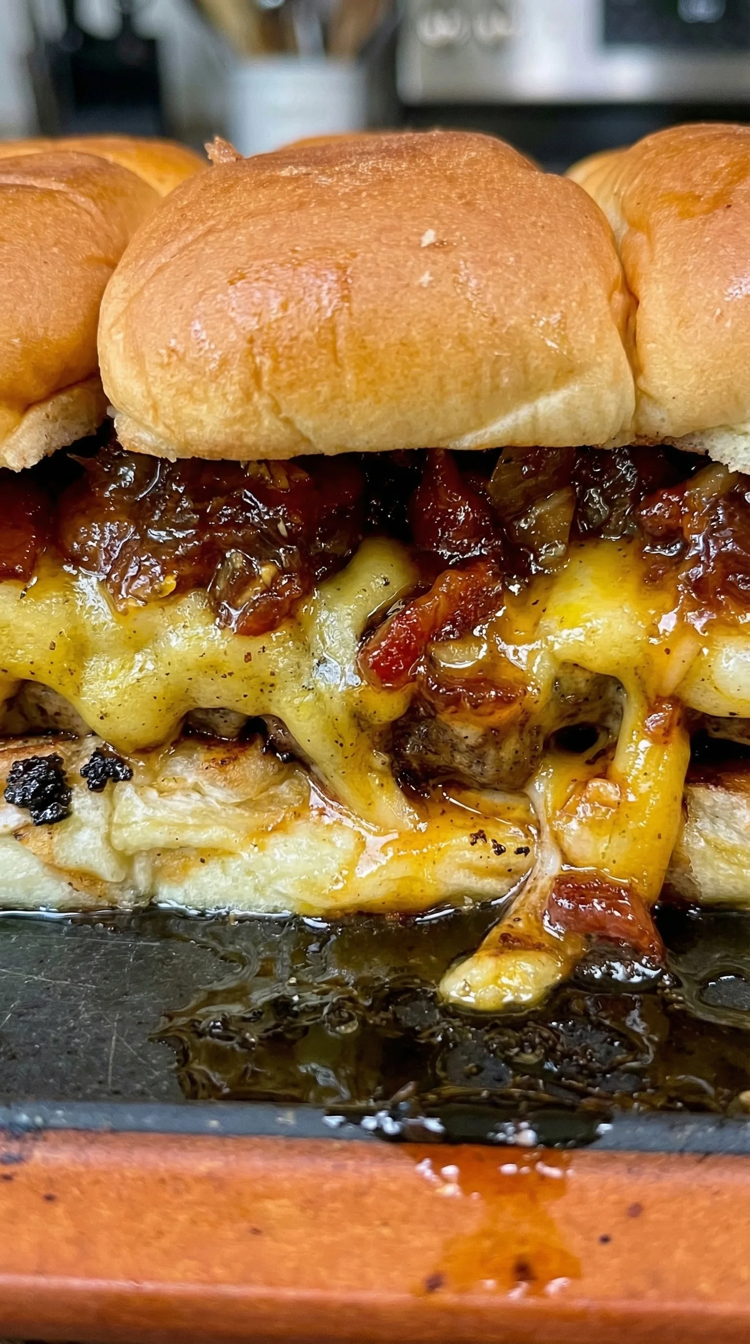 A close up of a cheeseburger with onions.