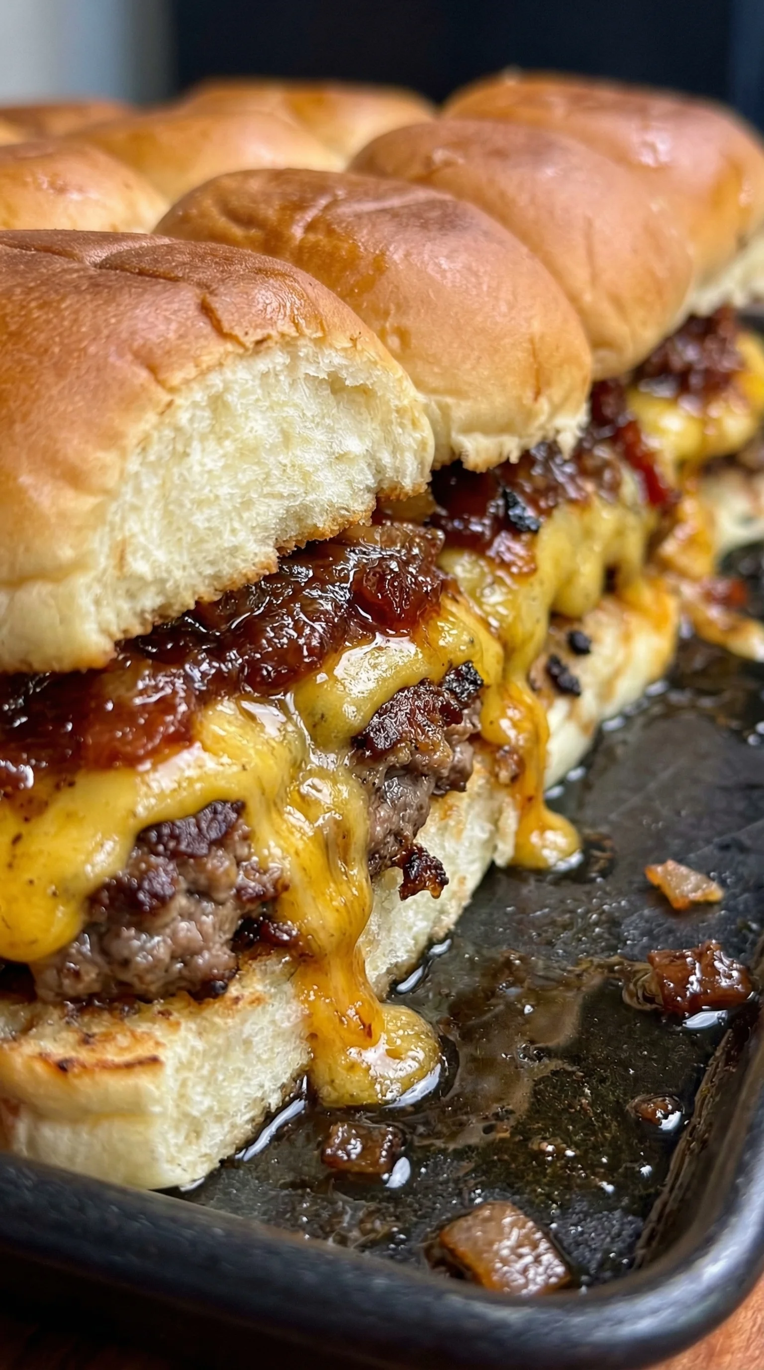 A close up of a cheeseburger with bacon.