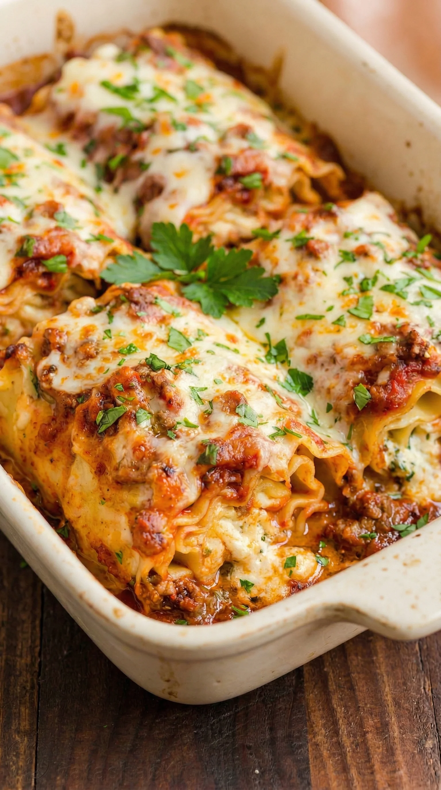 A dish of lasagna with cheese and herbs.