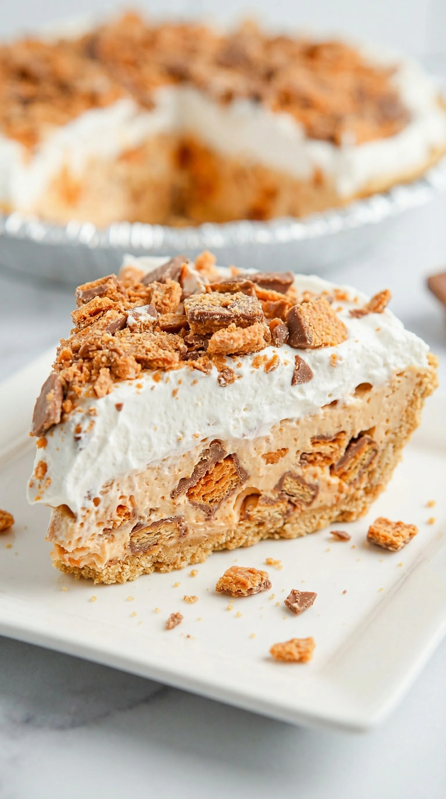 A slice of pie with chocolate and caramel toppings.