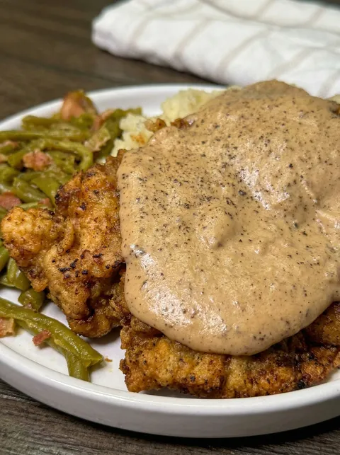 A plate of food with gravy on it.