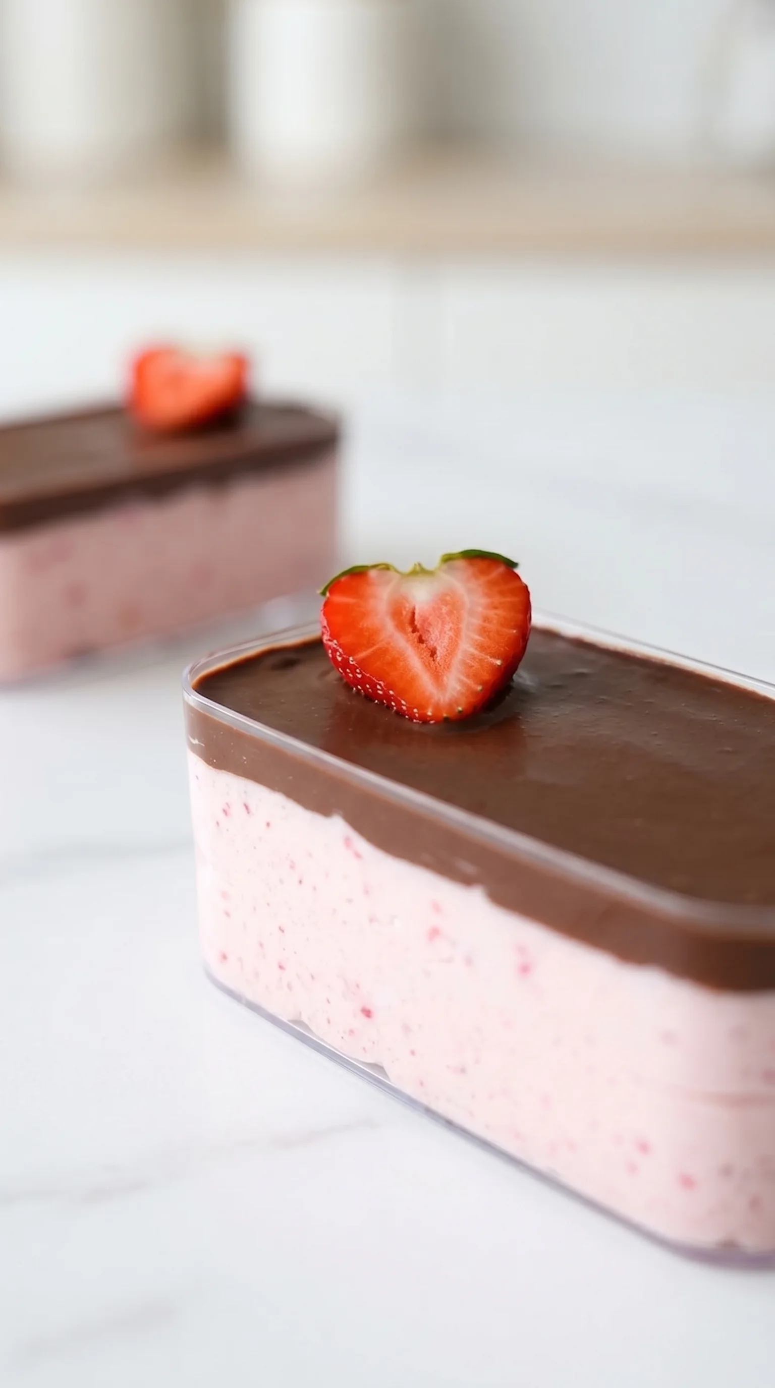 A slice of chocolate covered strawberry cheesecake.
