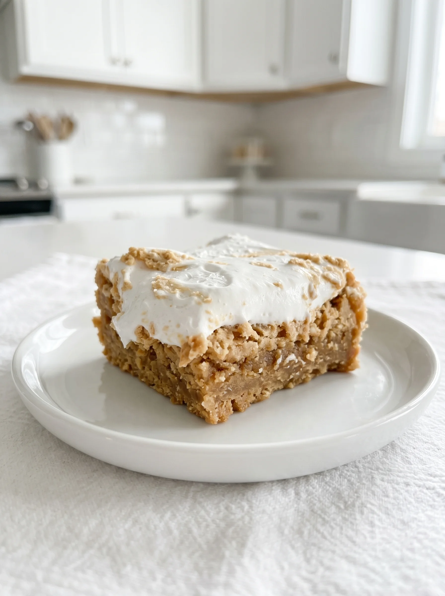 A white plate with a piece of fluffernutter bars.
