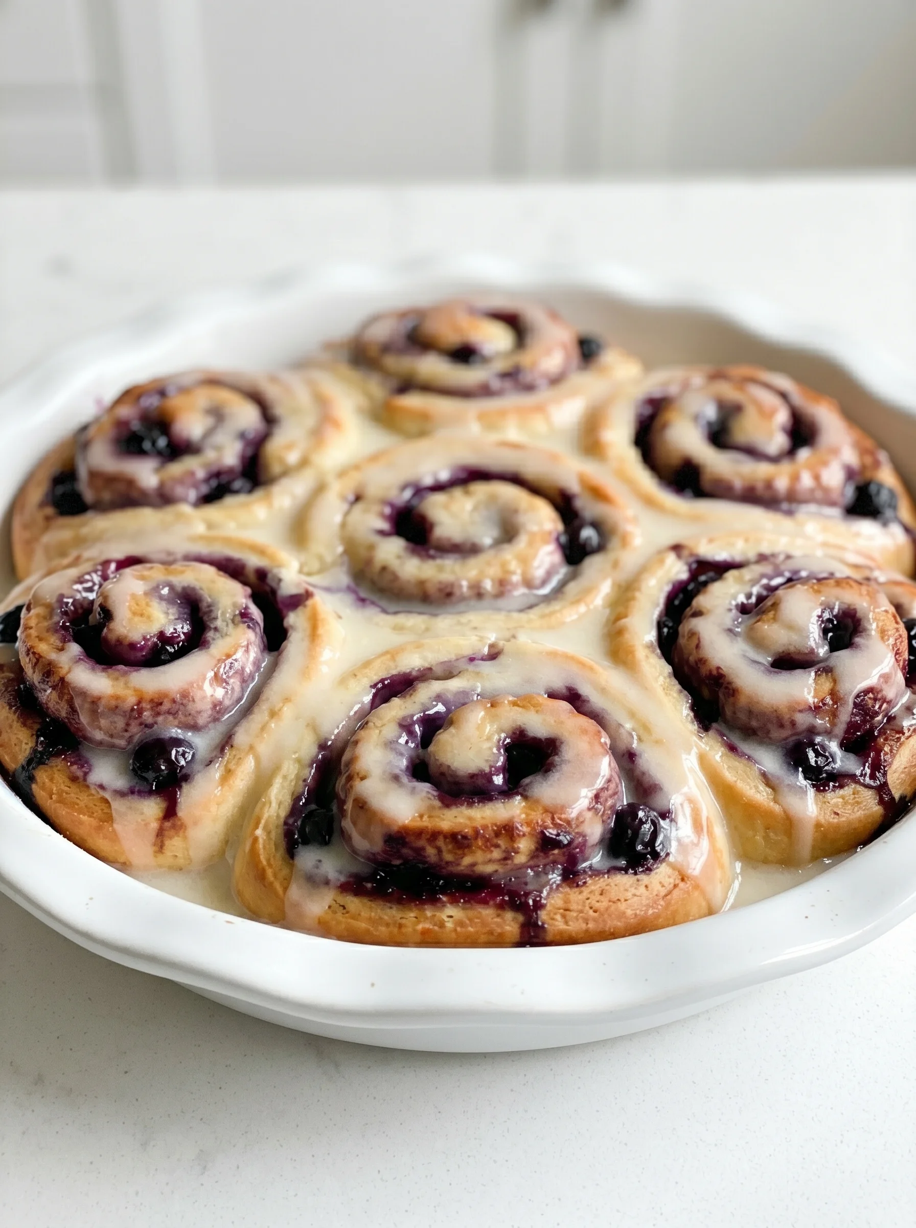 A plate of blueberry lemon sweet rolls.