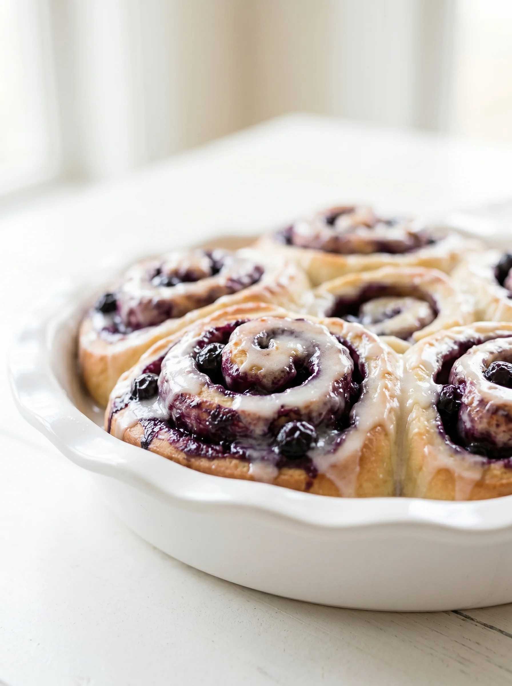 A plate of blueberry lemon rolls.