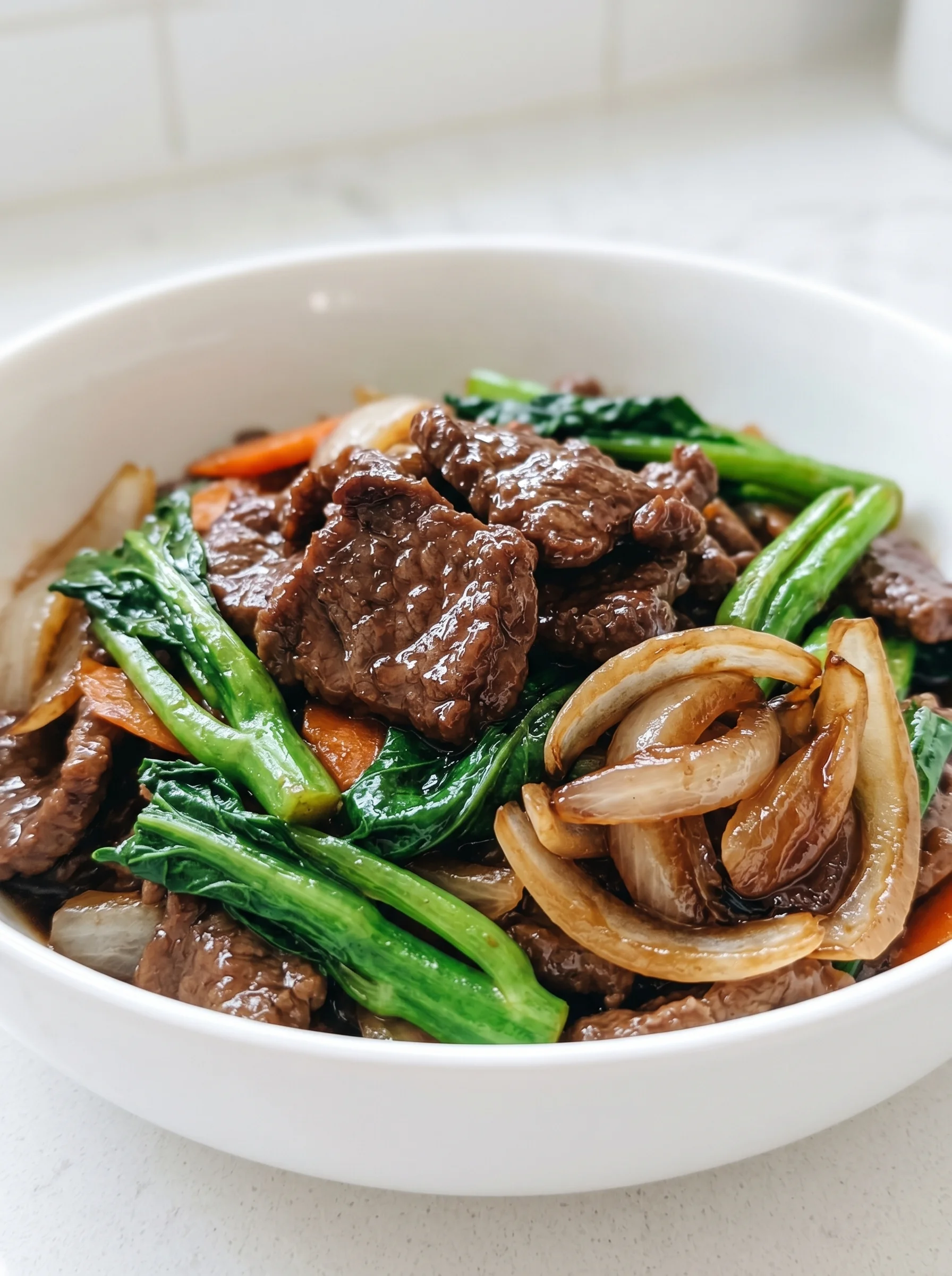 A bowl of beef and onions.