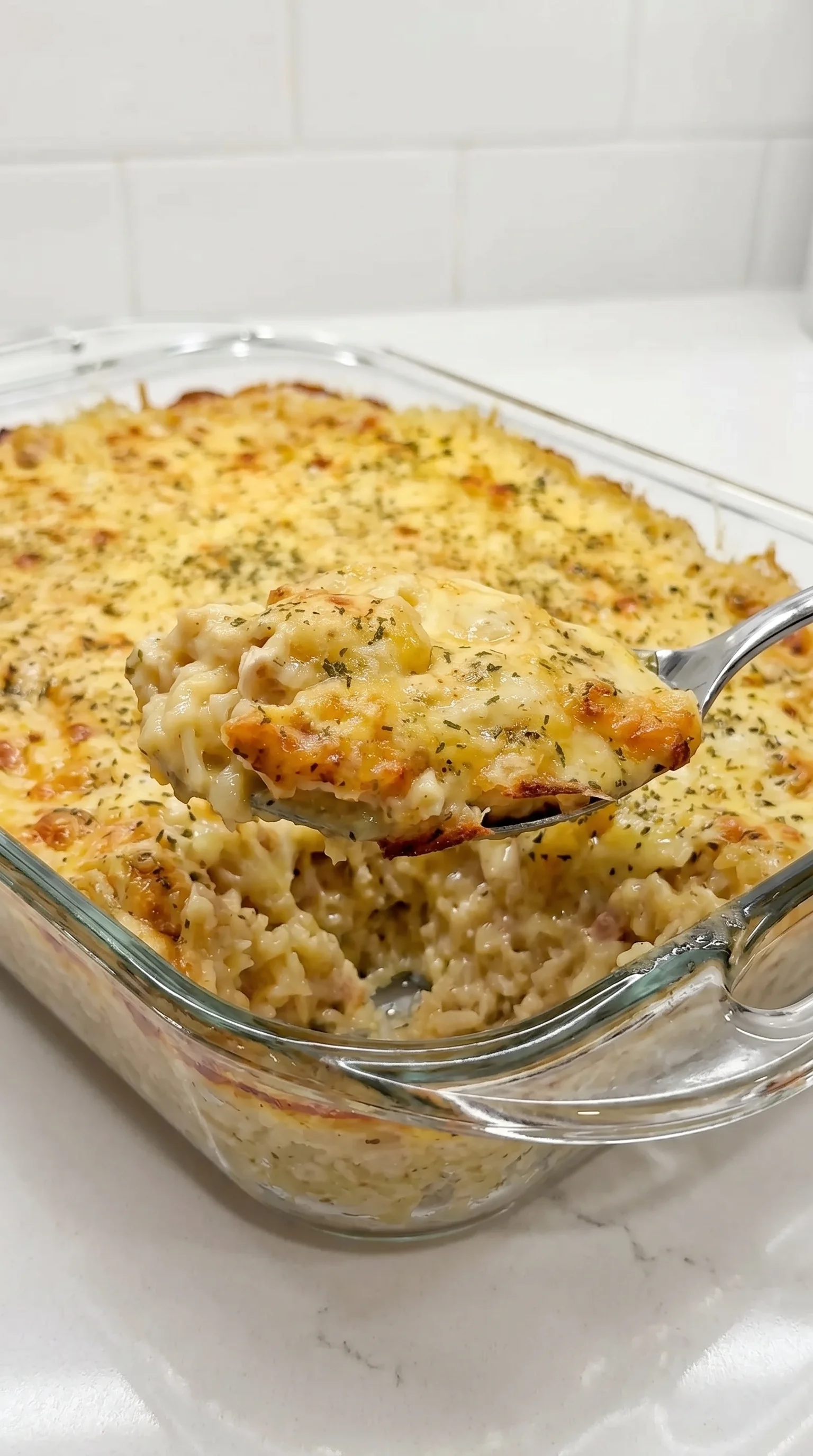 A fork is being used to eat a lemon chicken orzo bake.