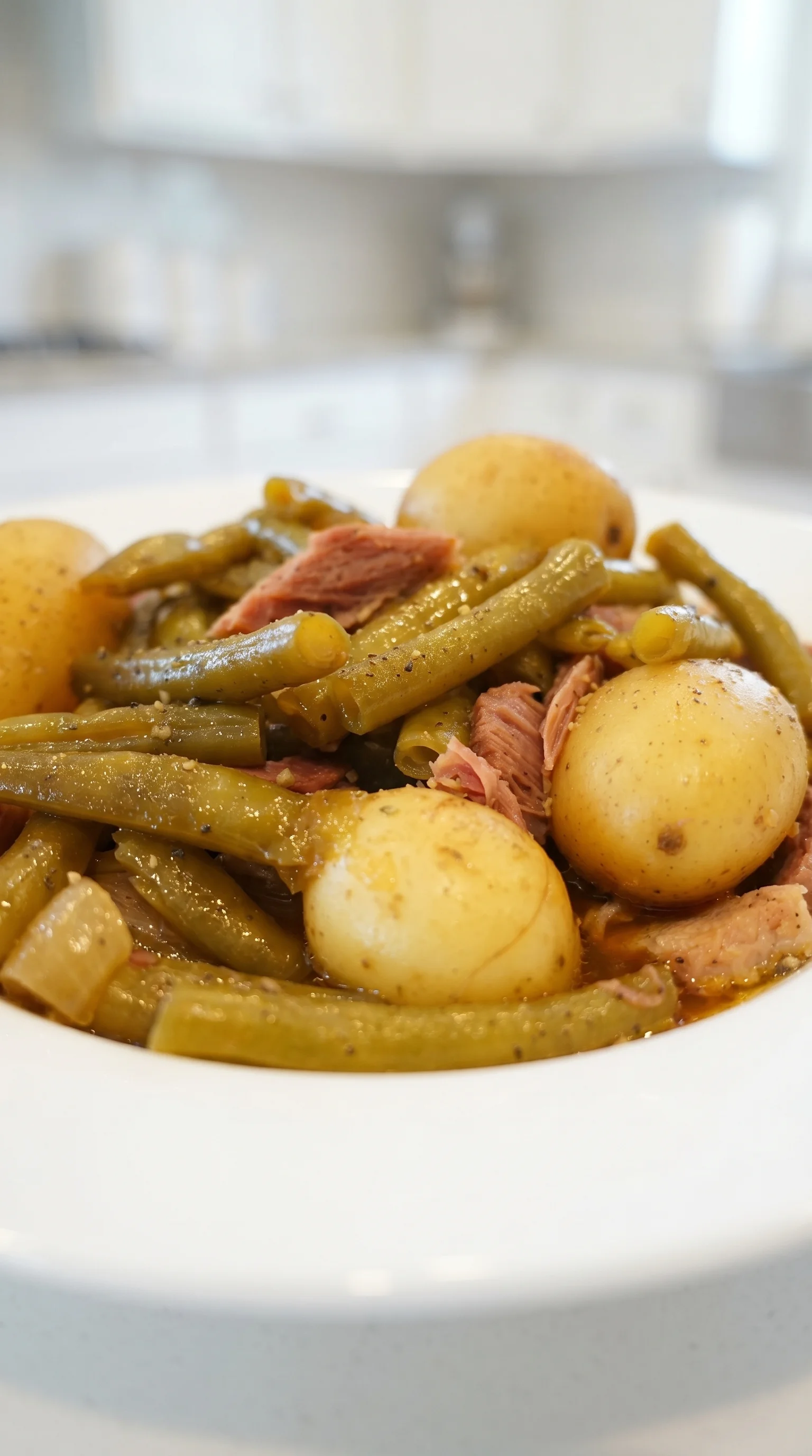 A plate of slow cooker green beans, ham and potatoes.