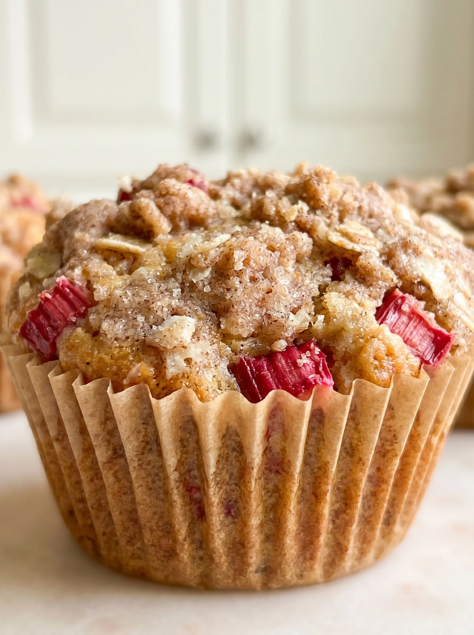 A muffin with a red topping.