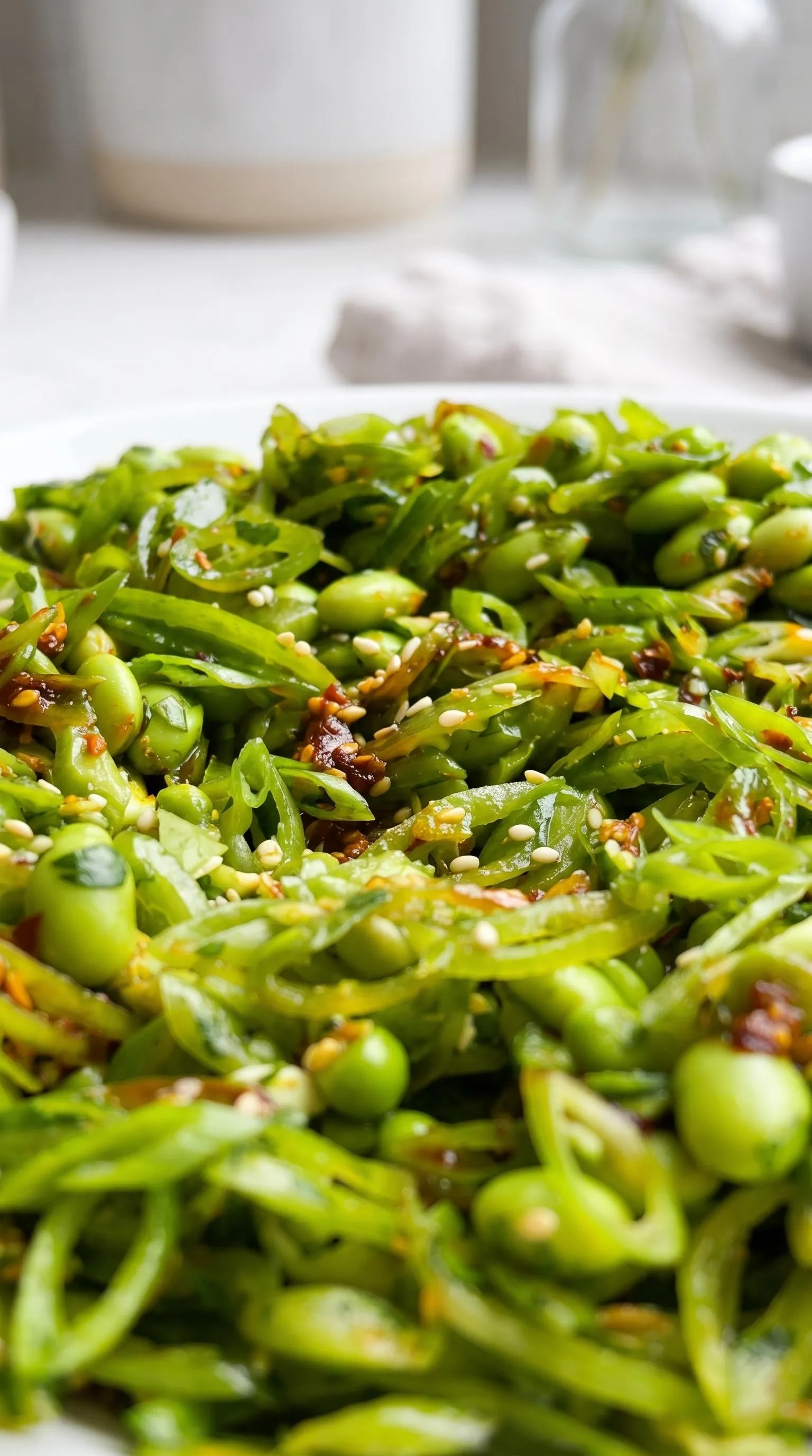 A chili crisp snap pea salad on a plate.