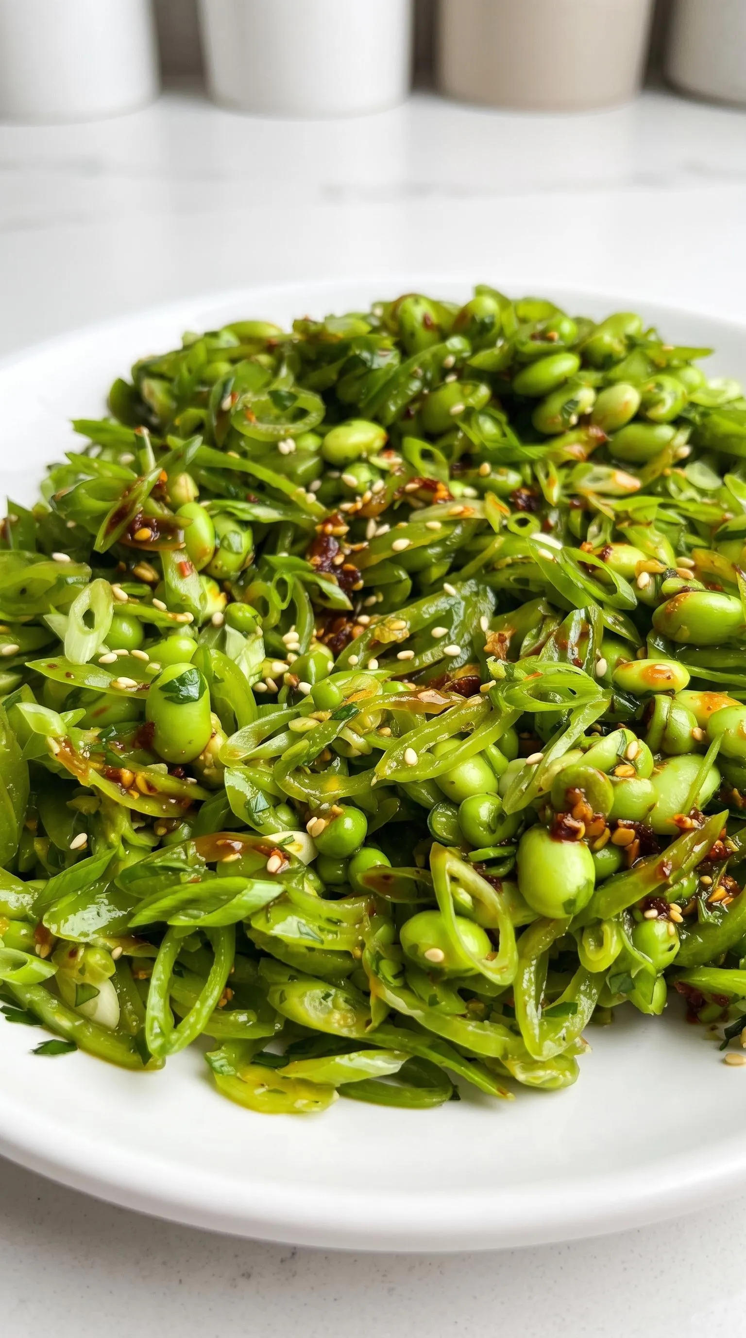 A plate of chili crisp snap pea salad.