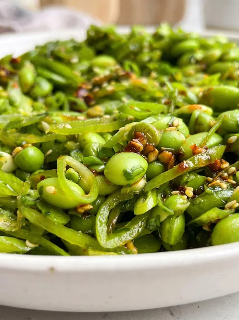 A bowl of chili crisp snap pea salad.