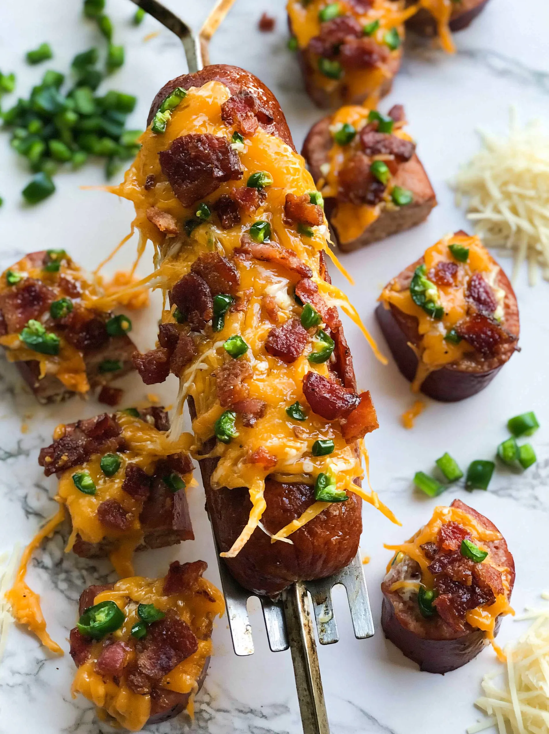 Grilled jalapeno popper sausage skewers with cheese and bacon.