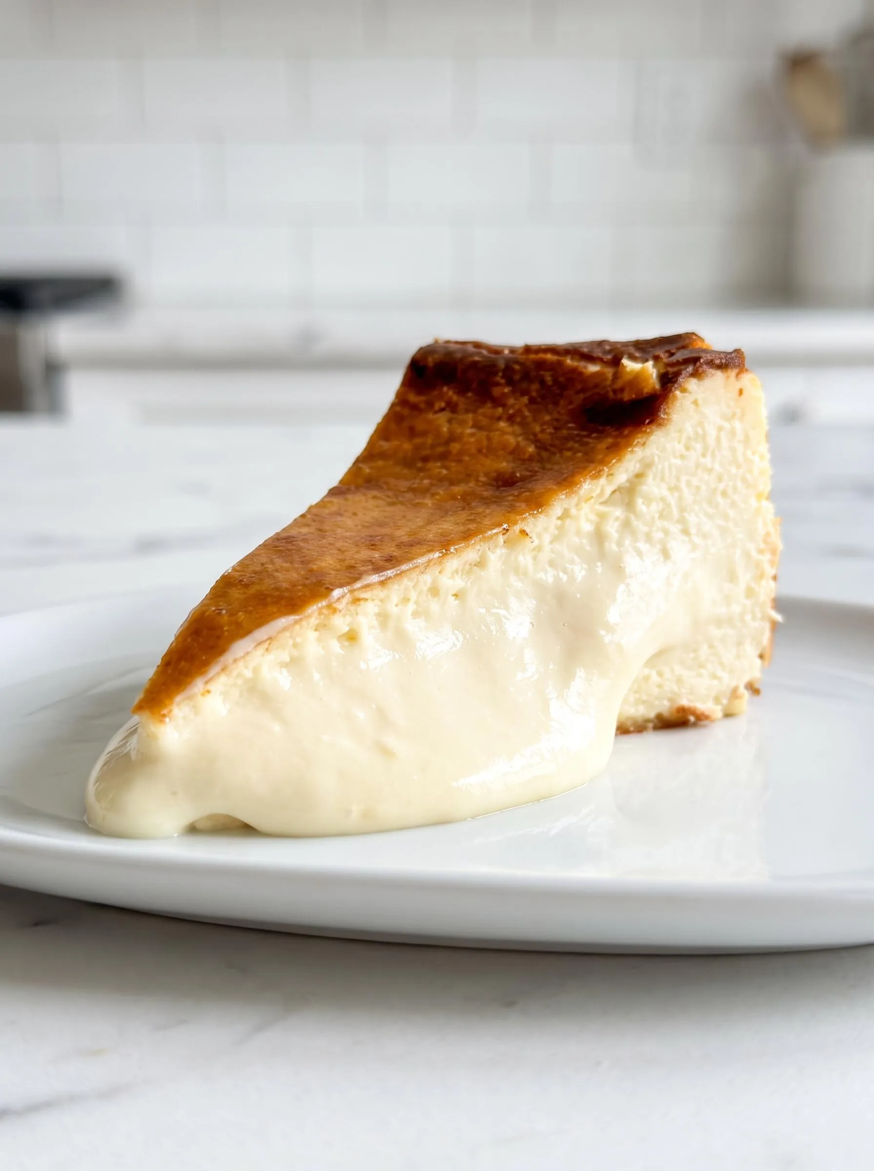 A slice of Basque cheesecake on a plate.