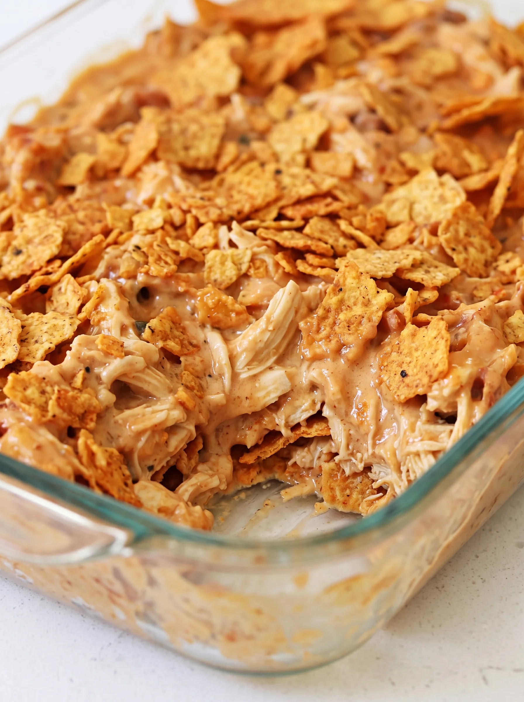 A dish of chicken covered in Doritos chips.