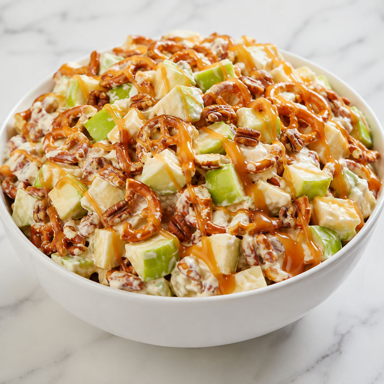 Caramel apple pretzel salad with apples, caramel, pretzels, and pecans