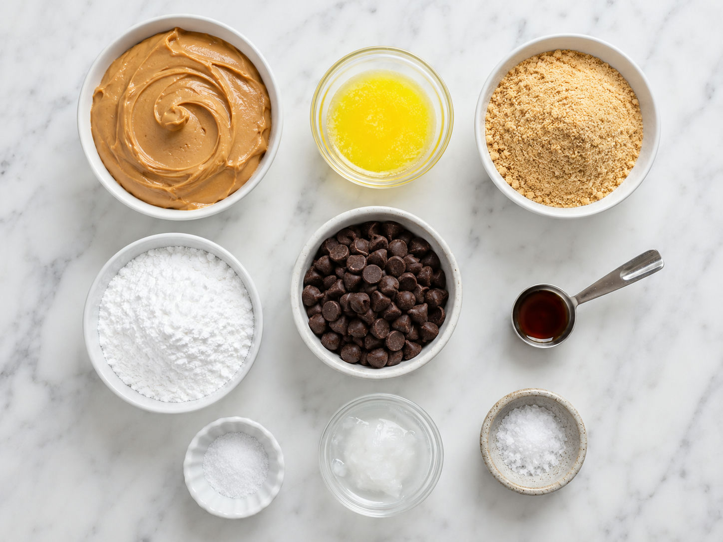 Ingredients for peanut butter chocolate bars arranged on a wooden surface