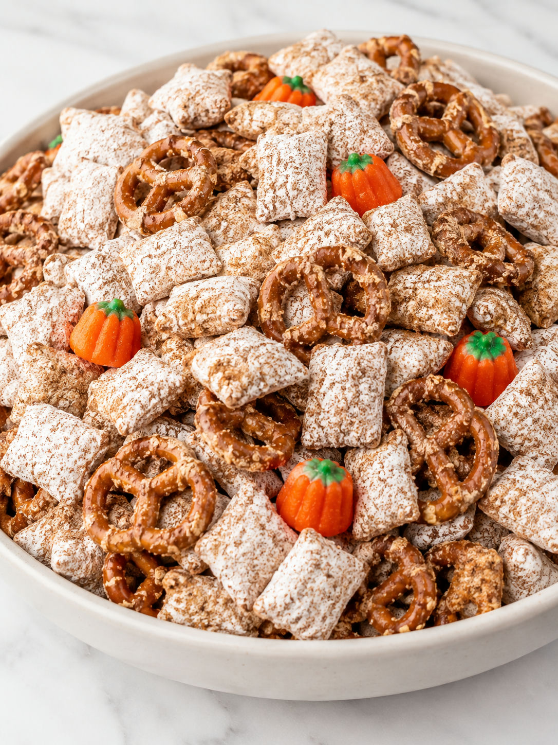 Top-down pumpkin spice puppy chow with pretzels and fall candy