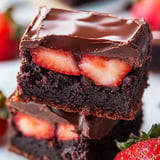 A chocolate dessert with strawberries on top.