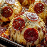 A pan of pepperoni and cheese stuffed meatballs.