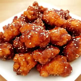 A plate of chicken wings with a brown sauce on top.