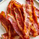 Bacon on a white plate.