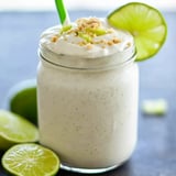 A glass of white cream with a green lime wedge on top.