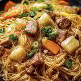 A bowl of noodles with meat and vegetables.