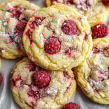 A plate of cookies with raspberry jam.