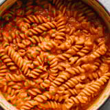 A bowl of pasta with sauce.